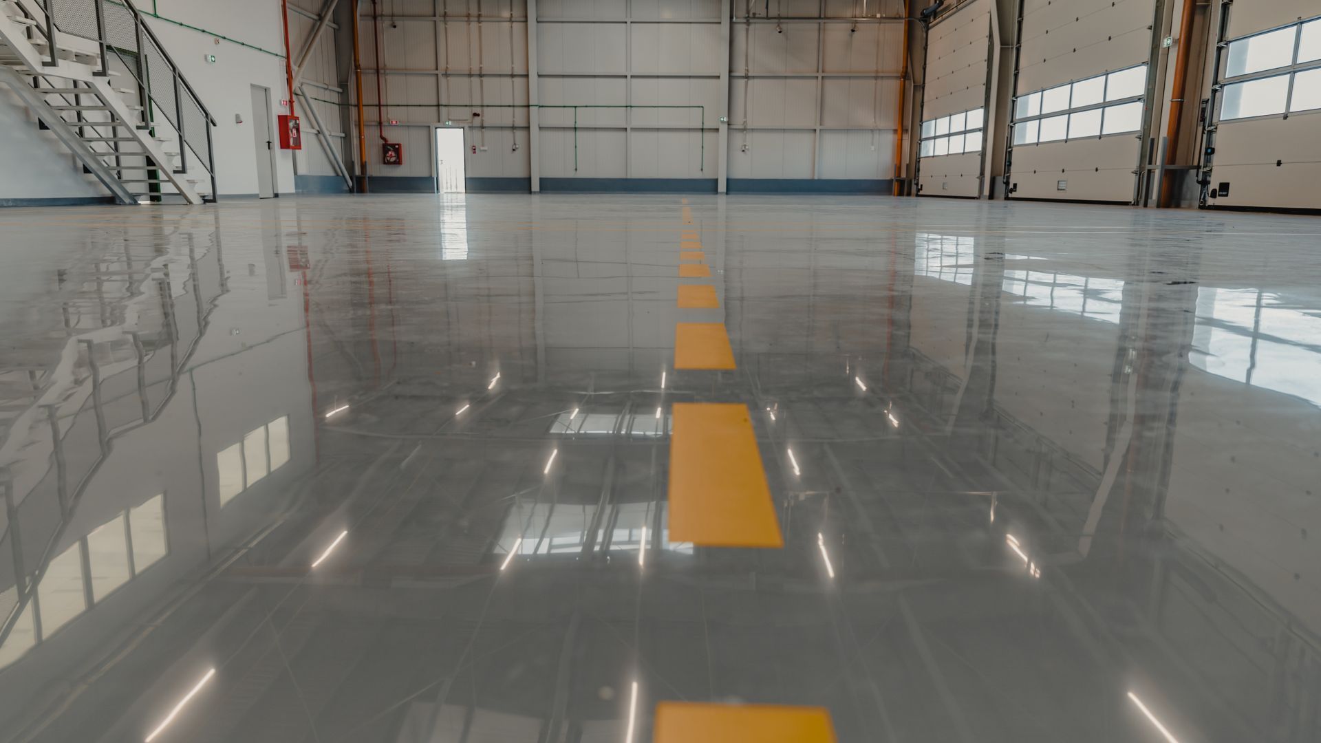 An empty warehouse with a yellow line on the floor