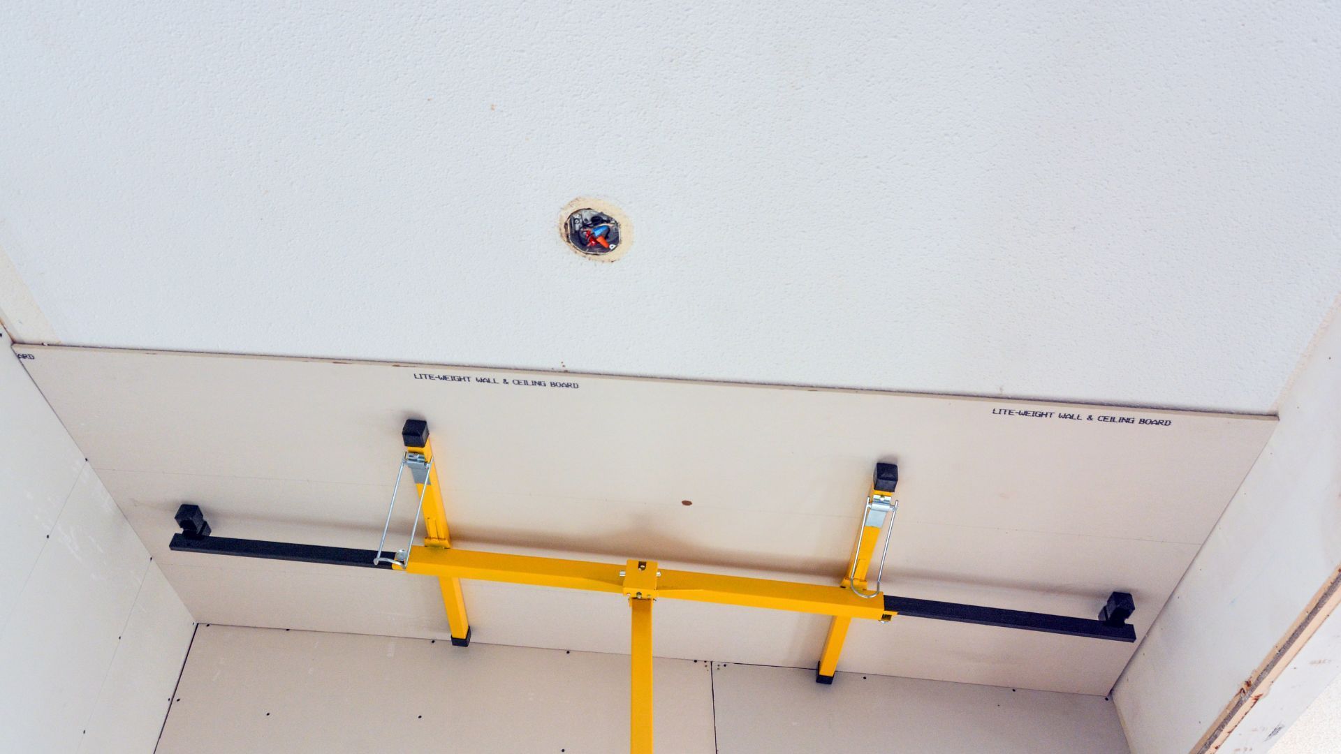A yellow bar is hanging from the ceiling of a room