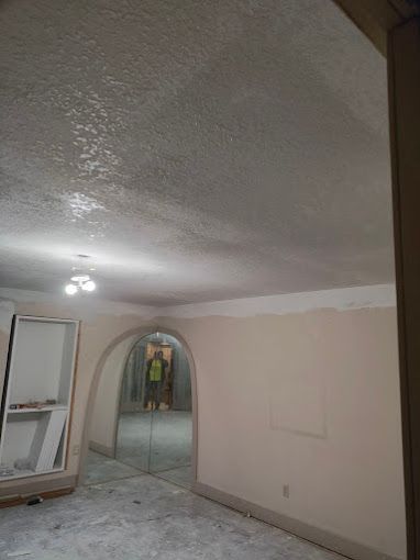 A room with a ceiling that has been painted white and a doorway.