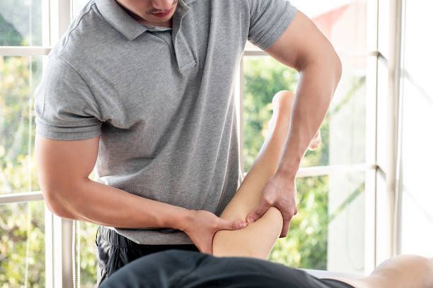 Man receiving chiropractic adjustment on a table. Practitioner holds his arm and shoulder.