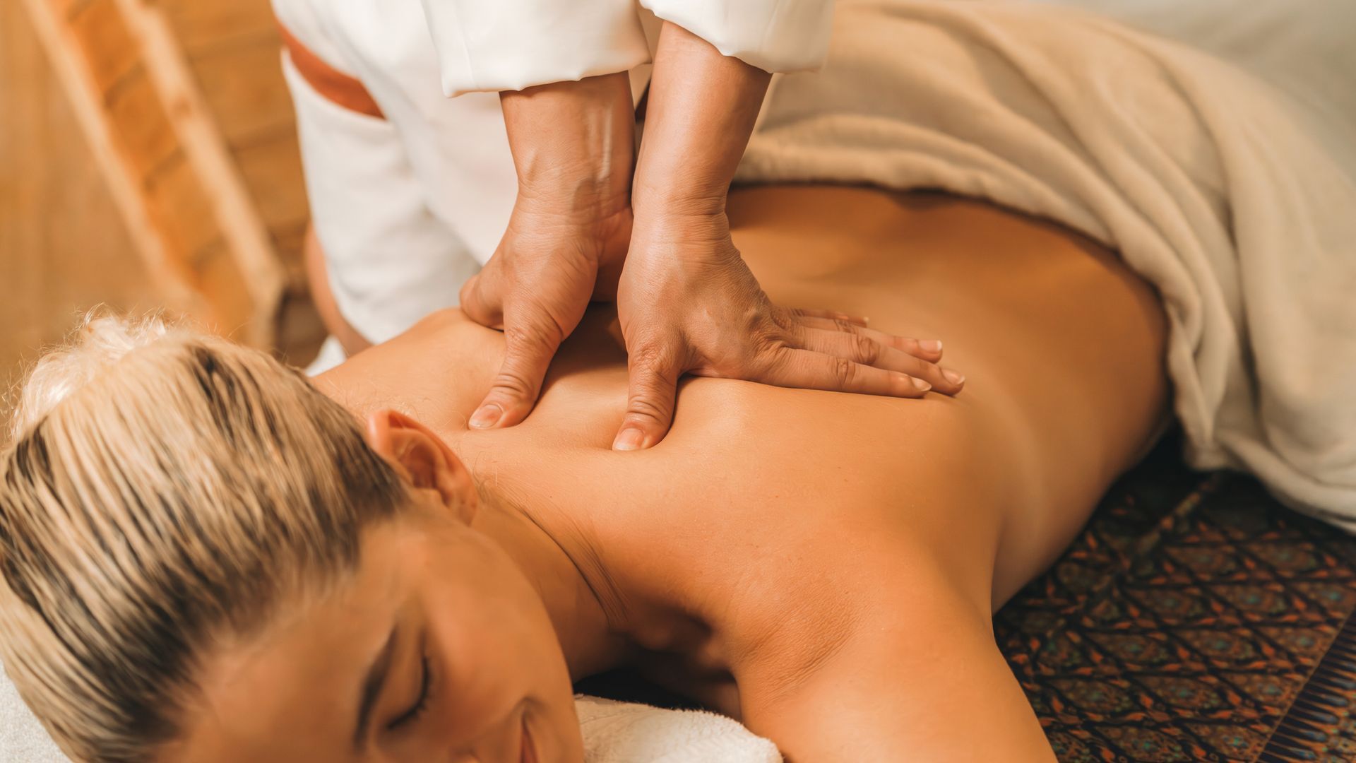 Person receiving a back massage at a spa.