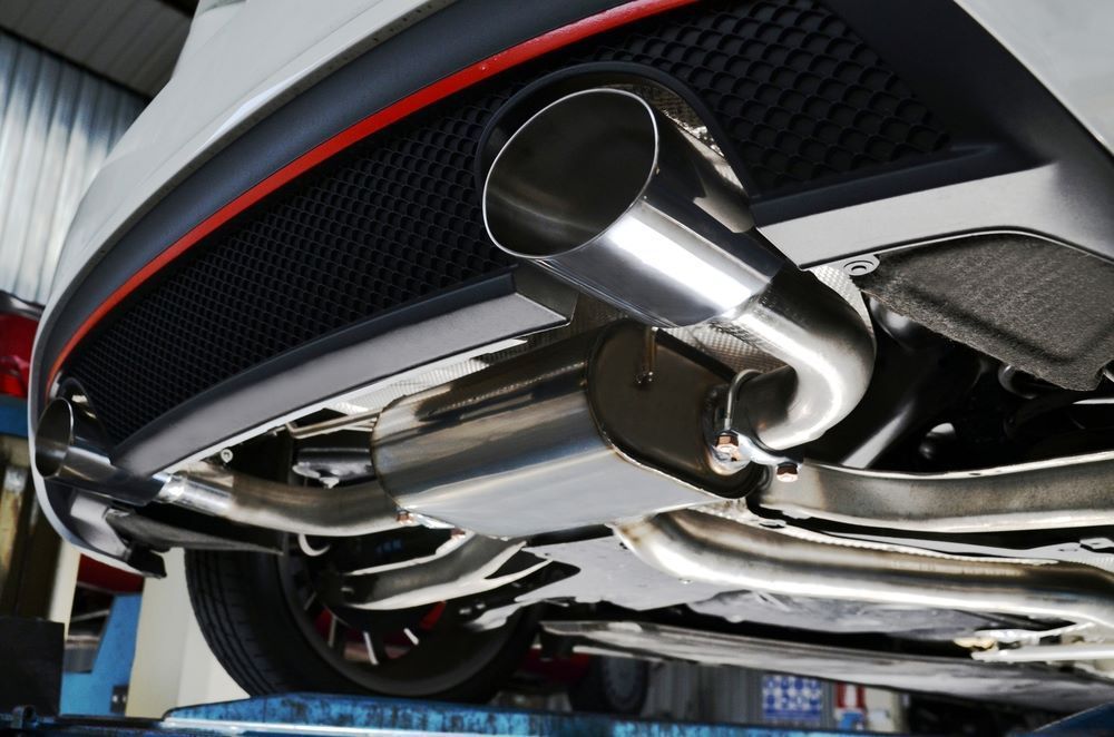 A Car With a Stainless Steel Exhaust Pipe is Sitting on a Lift — Sprint Mufflers, Exhausts & Mechanical Repairs in Stuart, NT