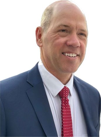 A man in a suit and tie is smiling for the camera.
