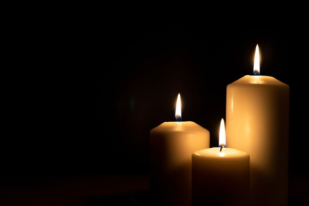 Three Candles Are Lit In The Dark On A Black Background — Territory Funerals In Howard Springs, NT