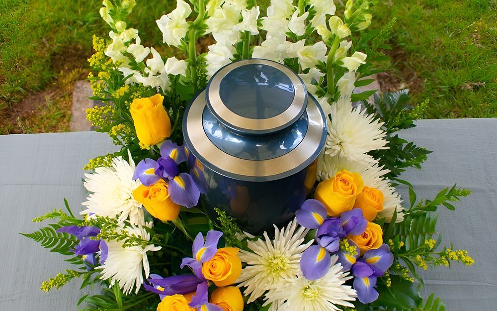 Blue Urn Surrounded by a Floral Arrangement
