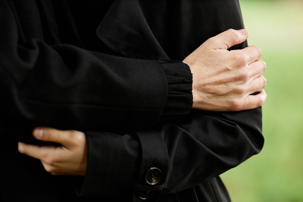 A Coffin Is Sitting In The Back Of A Limousine With Flowers On It — Territory Funerals In Humpty Doo, NT