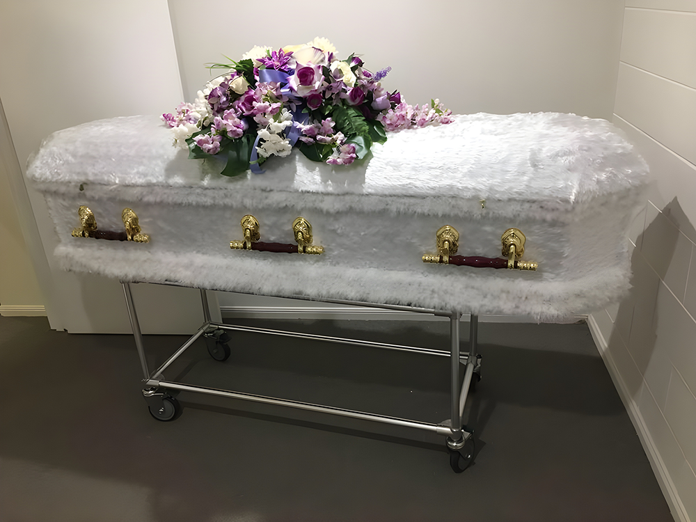 White Coffin with Floral Arrangement