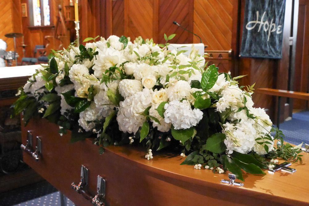 White Flowers On Top Of A Coffin
