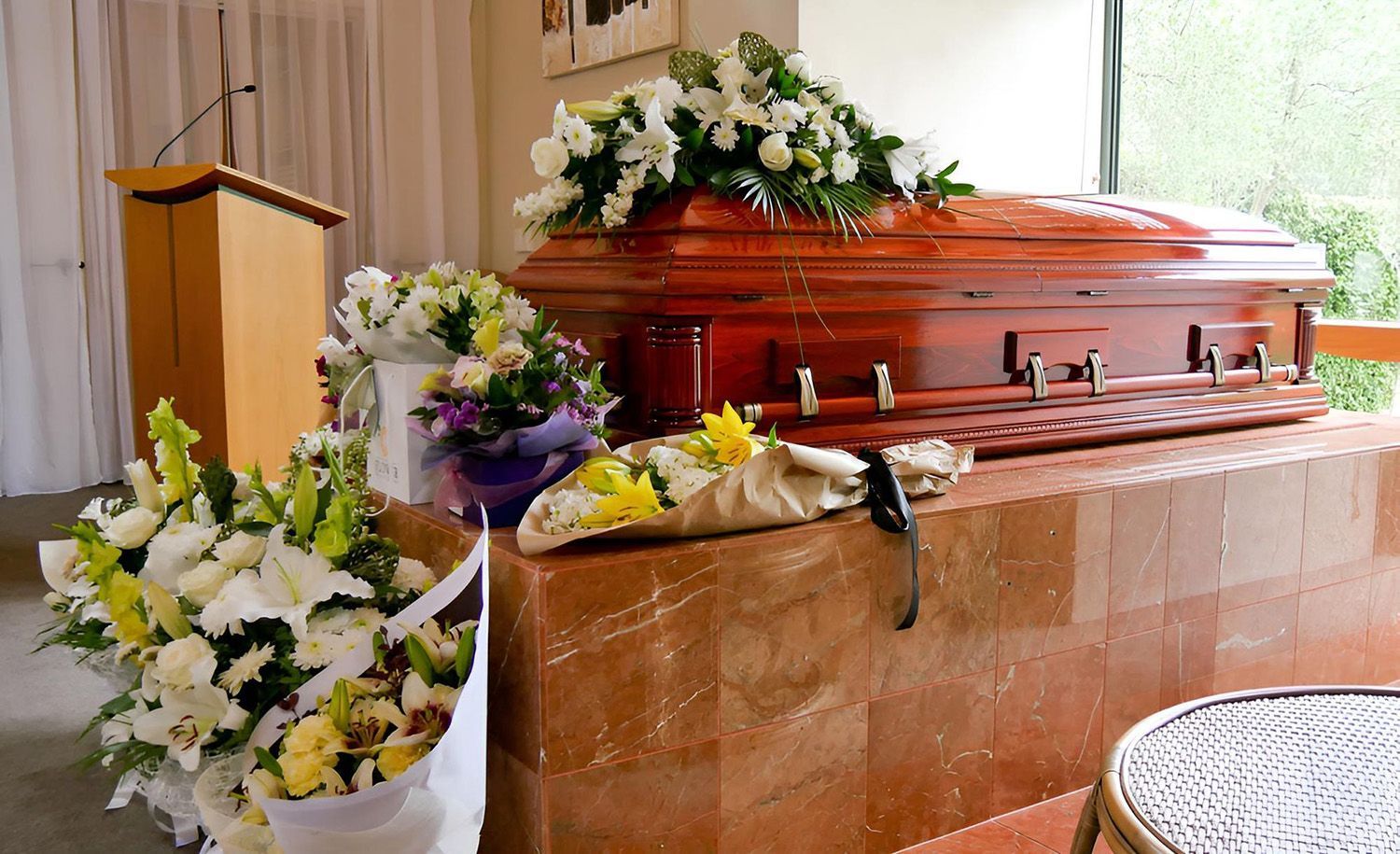 Wooden Coffin Adorned With Flowers At A Funeral