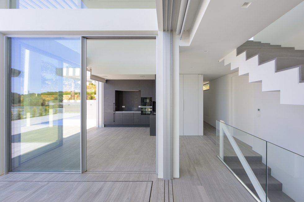 Contemporary house featuring glass walls, embodying minimalist architecture and modern design