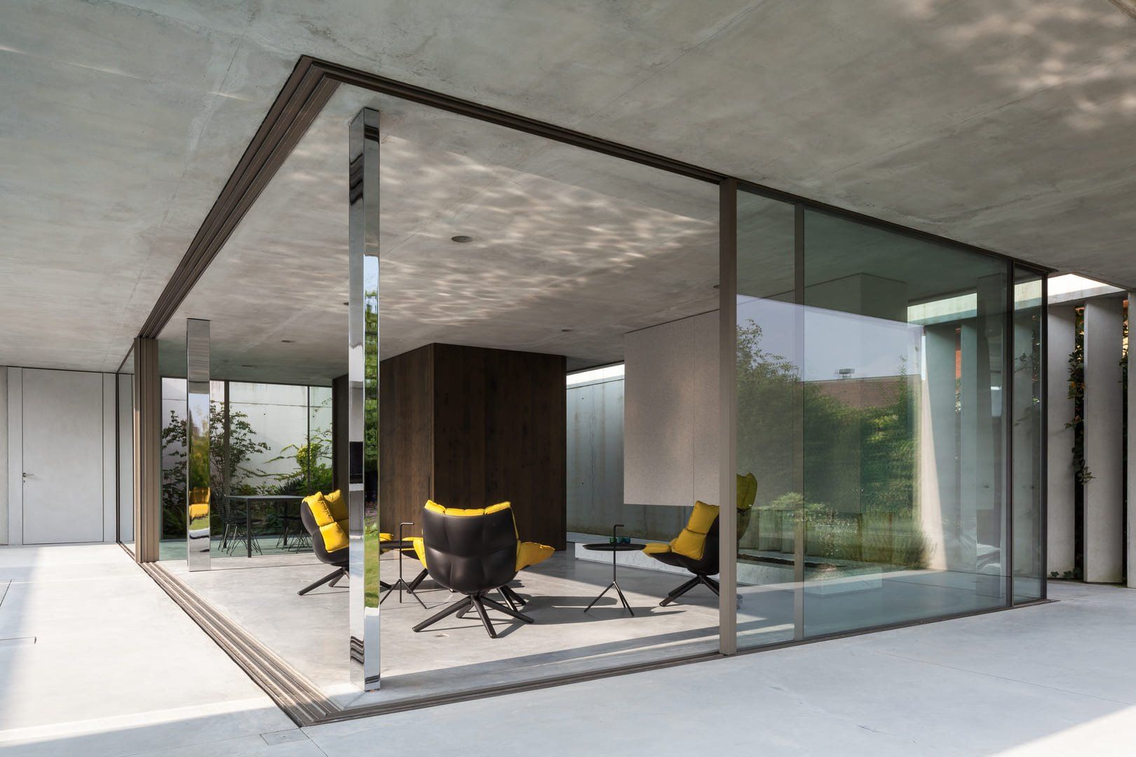 Glass-walled modern house, featuring minimalist window frame and contemporary design