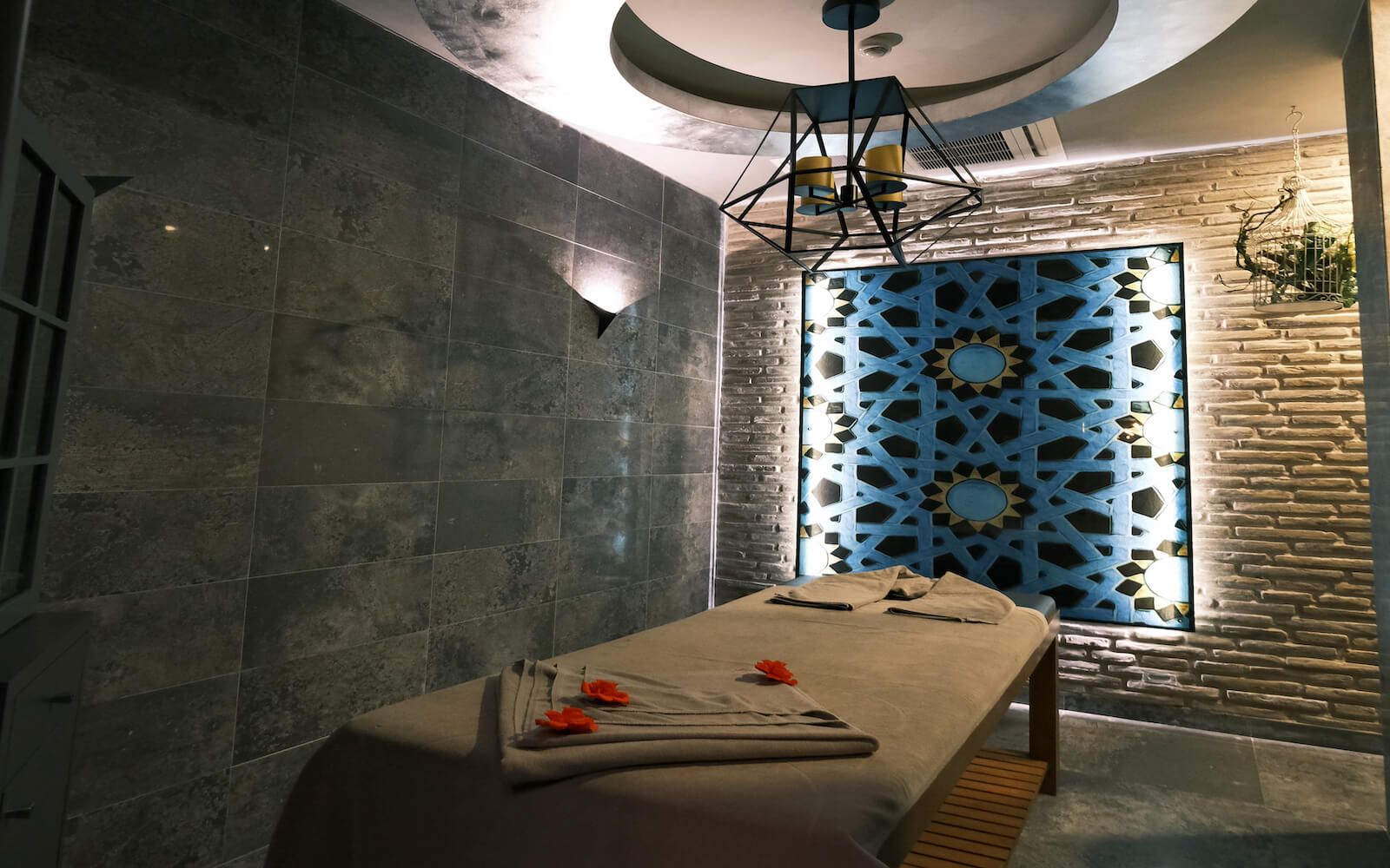 A massage table in a room with a brick wall