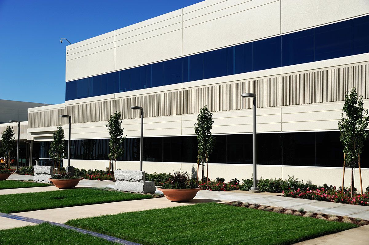 A large building with a lot of windows and trees in front of it