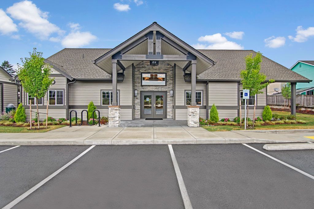 a large building with a parking lot in front of it .