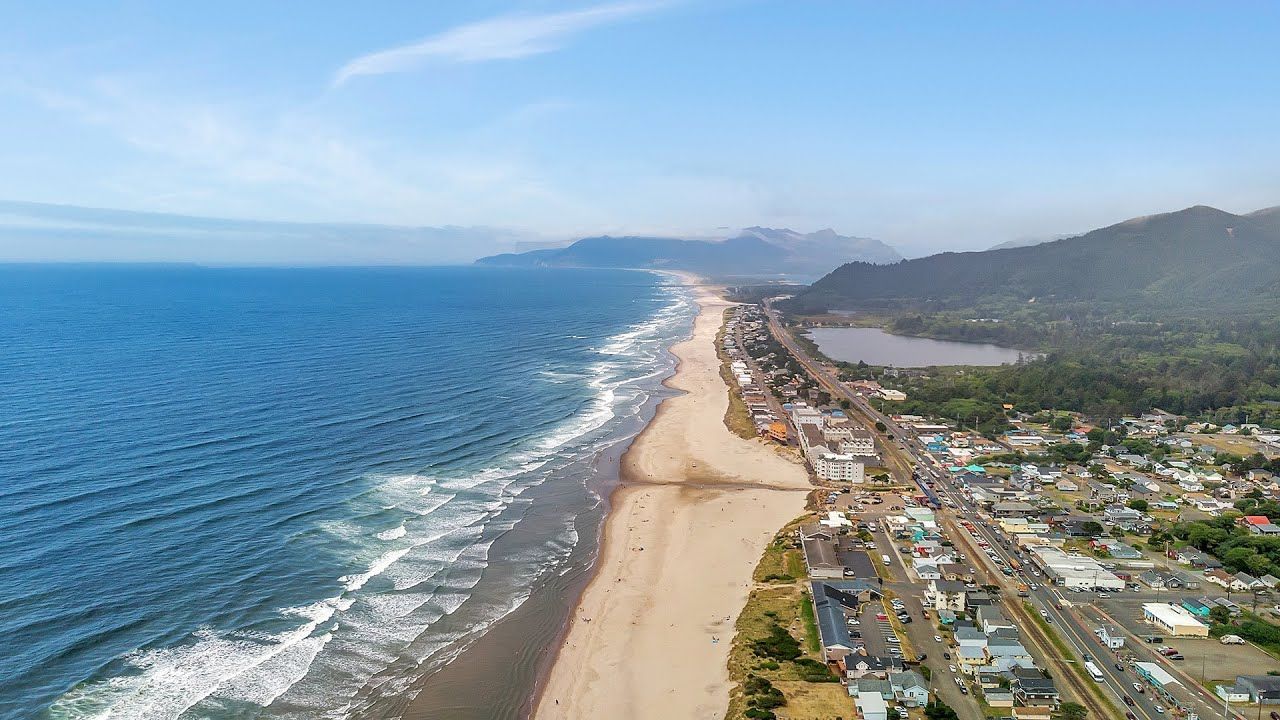 An aerial view of a beach with mountains in the background.