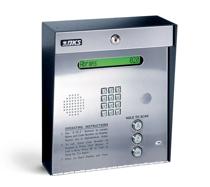 A silver and black box with a push button to call on it.