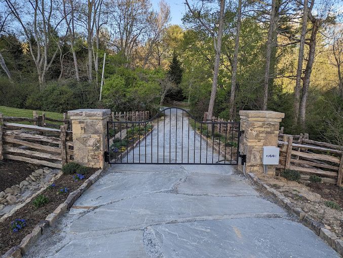 A gated entrance to a residential area with a speed limit of 25