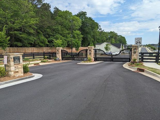 A gated entrance to a residential area with a speed limit of 25