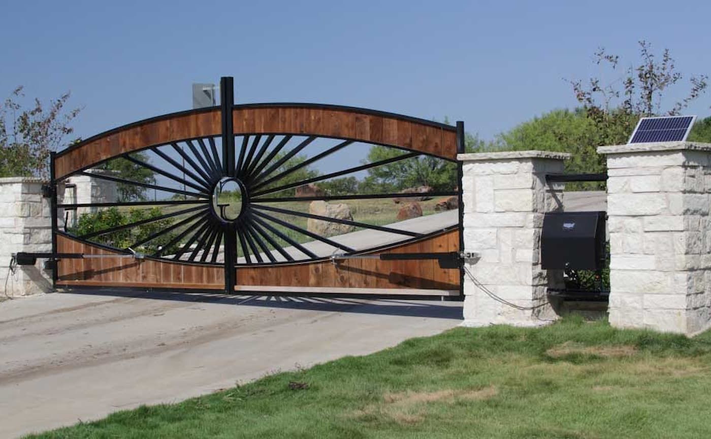 A wooden gate with a solar panel on top of it