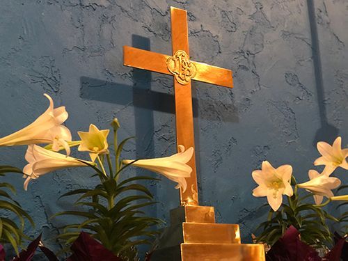 St. Anne's cross behind the altar with lilies