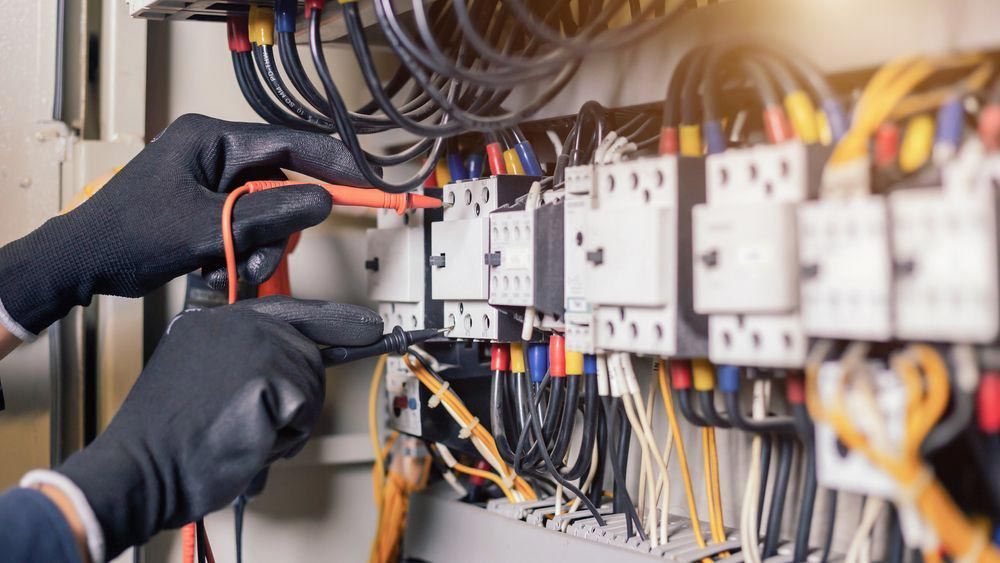 Commercial Electrician Inspecting Switches