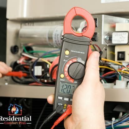A person is holding a digital multimeter that reads 1207
