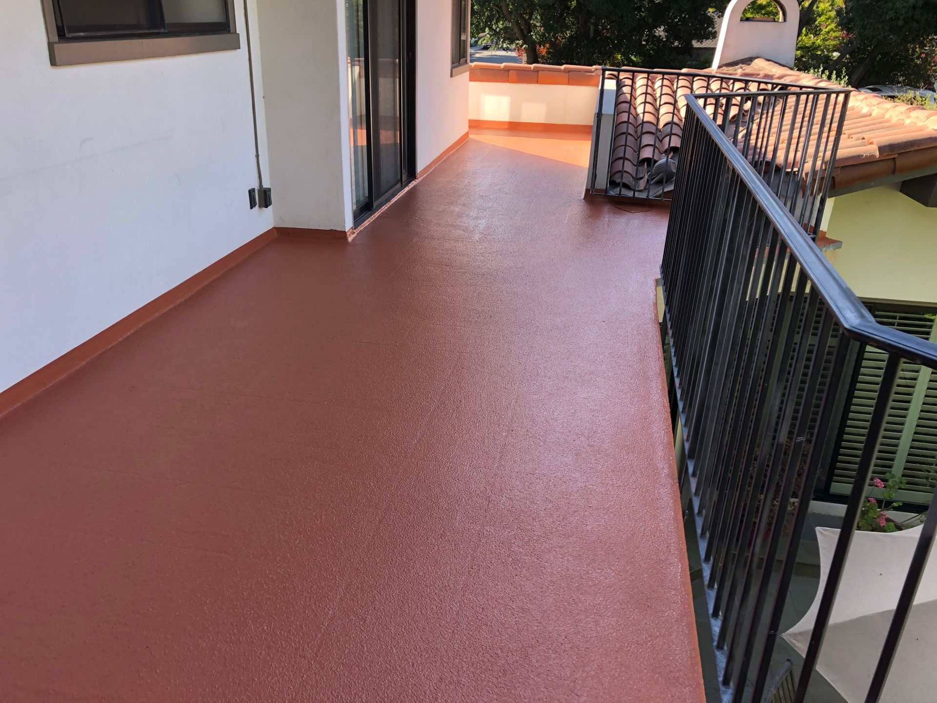 A Deck With a Table and Chairs Under an Awning