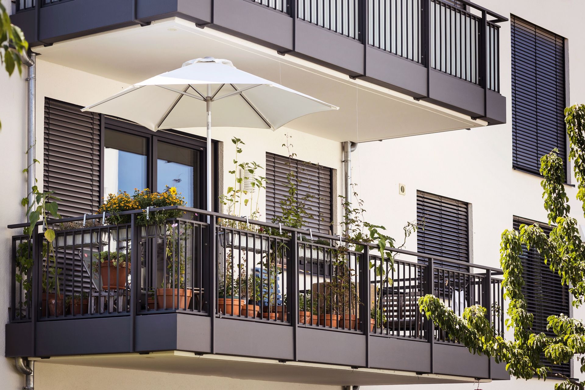 A Balcony With a White Umbrella on It