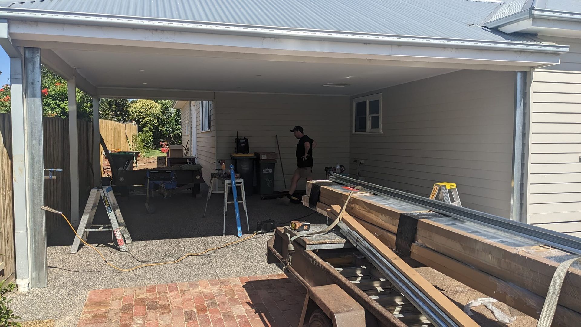 A Black Garage Door is Sitting in Front of a White House — Goldfields Garage Doors & Gates in Wendouree, VIC