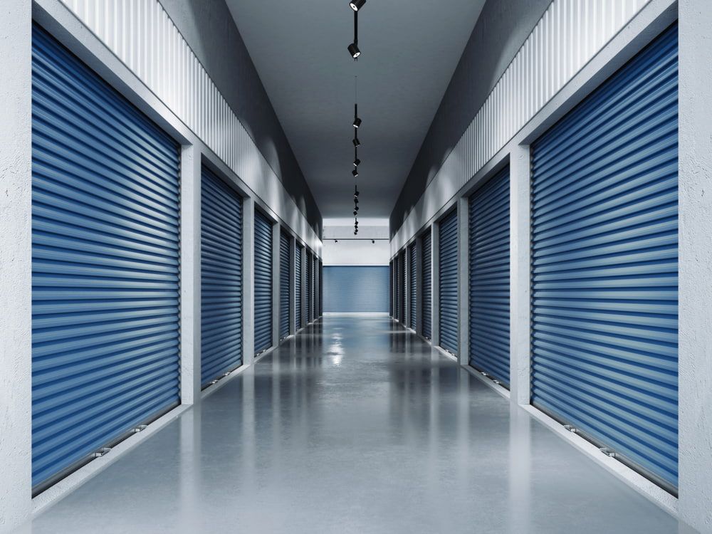 A Long Hallway With Blue Shutters on the Doors — Goldfields Garage Doors & Gates in Wendouree, VIC