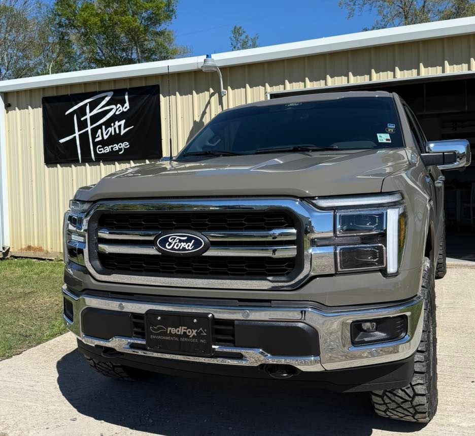 A tan Ford F-150 truck parked in front of a building with a 