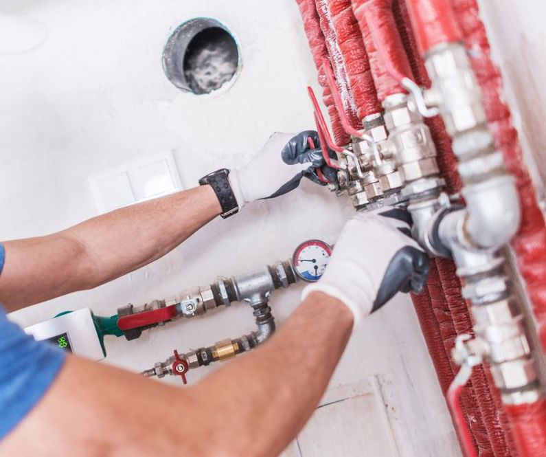 Person Wearing Gloves Adjusting Valves on Plumbing — Darwin Plumbing Maintenance in Knuckey Lagoon, NT