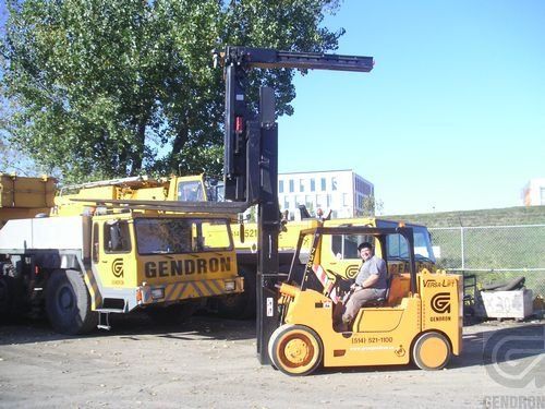 A gendron truck is parked next to a forklift