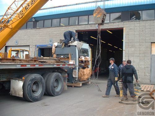 A group of men standing in front of a truck that says denorion