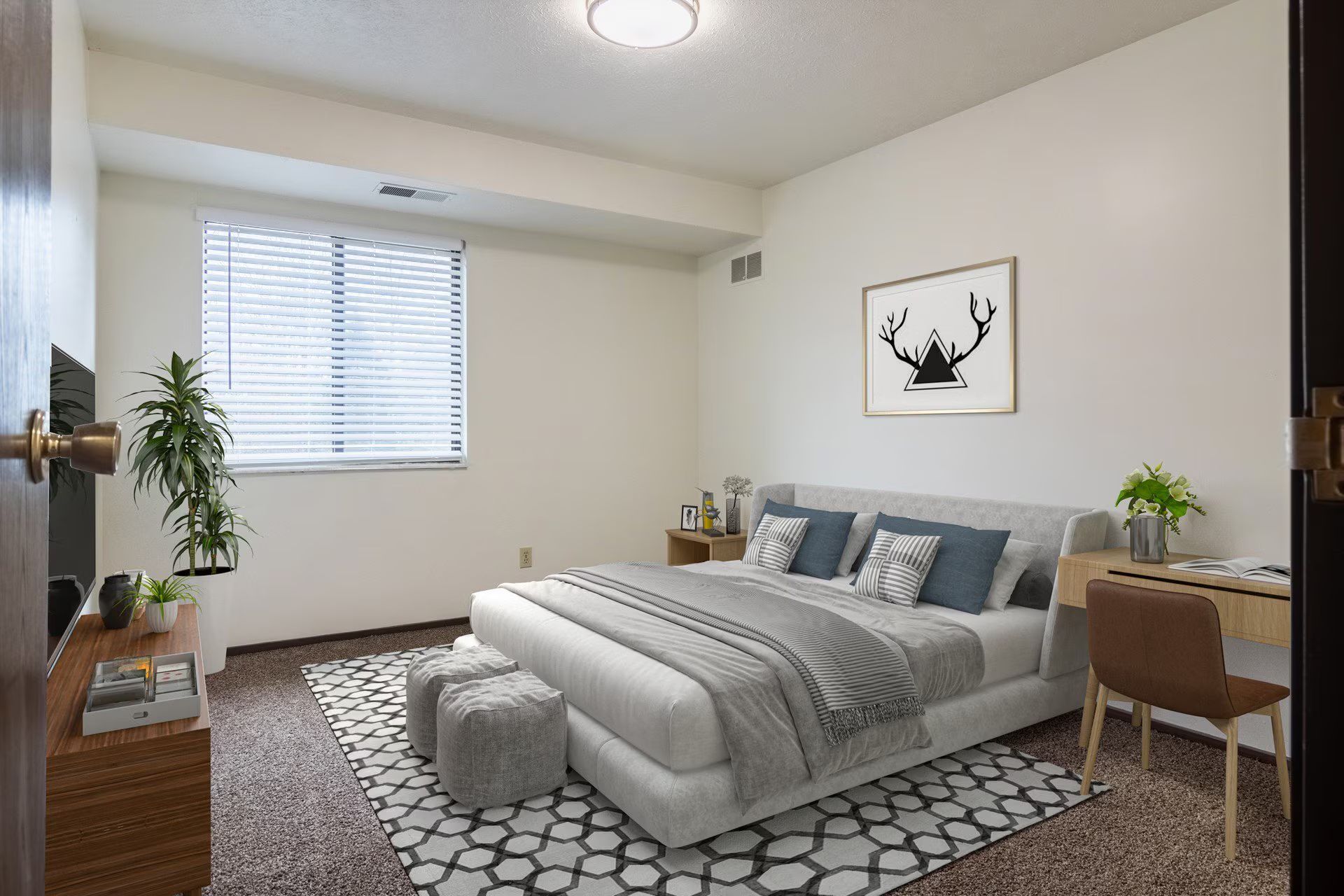 Bedroom with bed, desk, window, and decorative art.