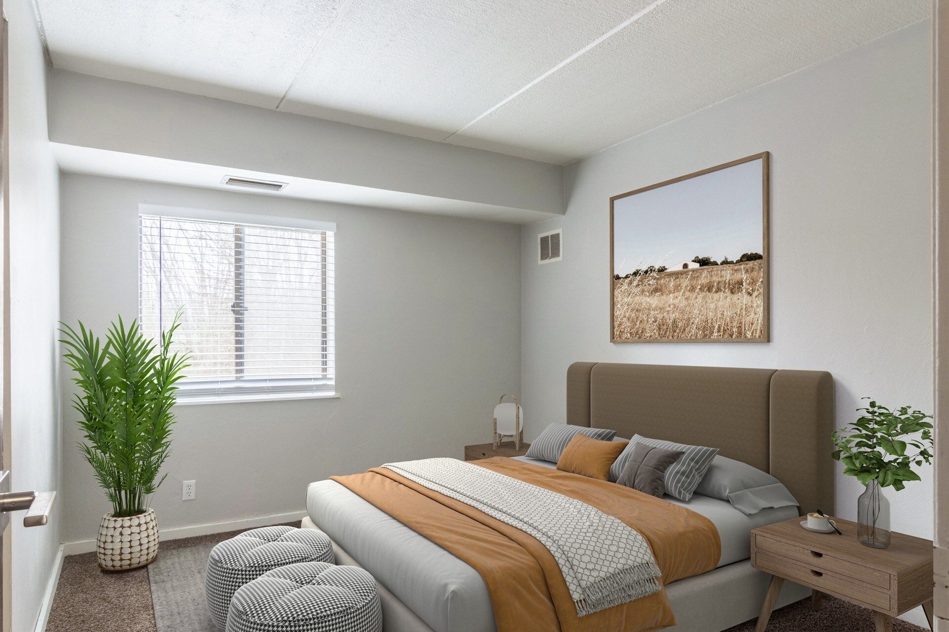 Bedroom with bed, art, window, potted plant, and ottoman. Neutral colors, natural light.