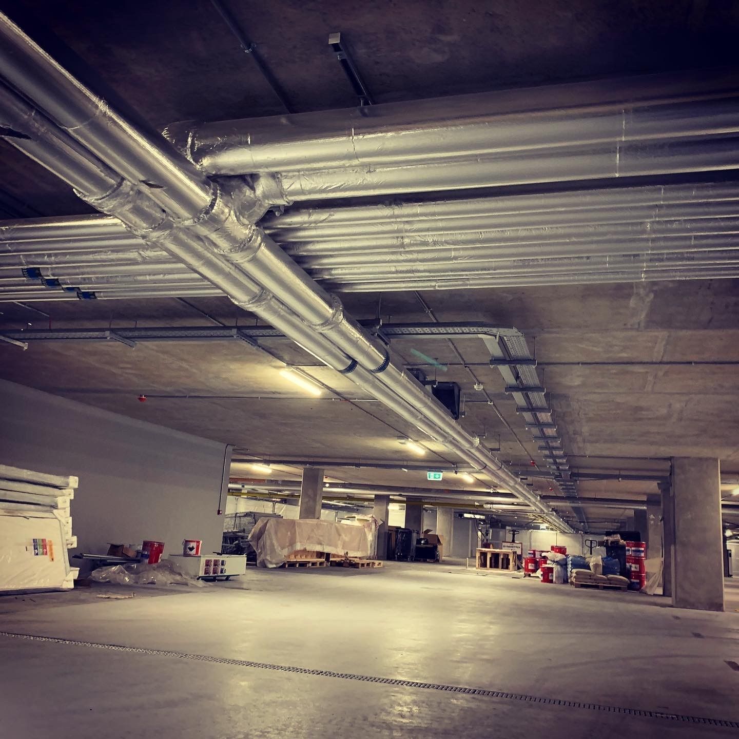 Underground car park services pipework insulated with foiled fiberglass lagging in Dublin Landings 