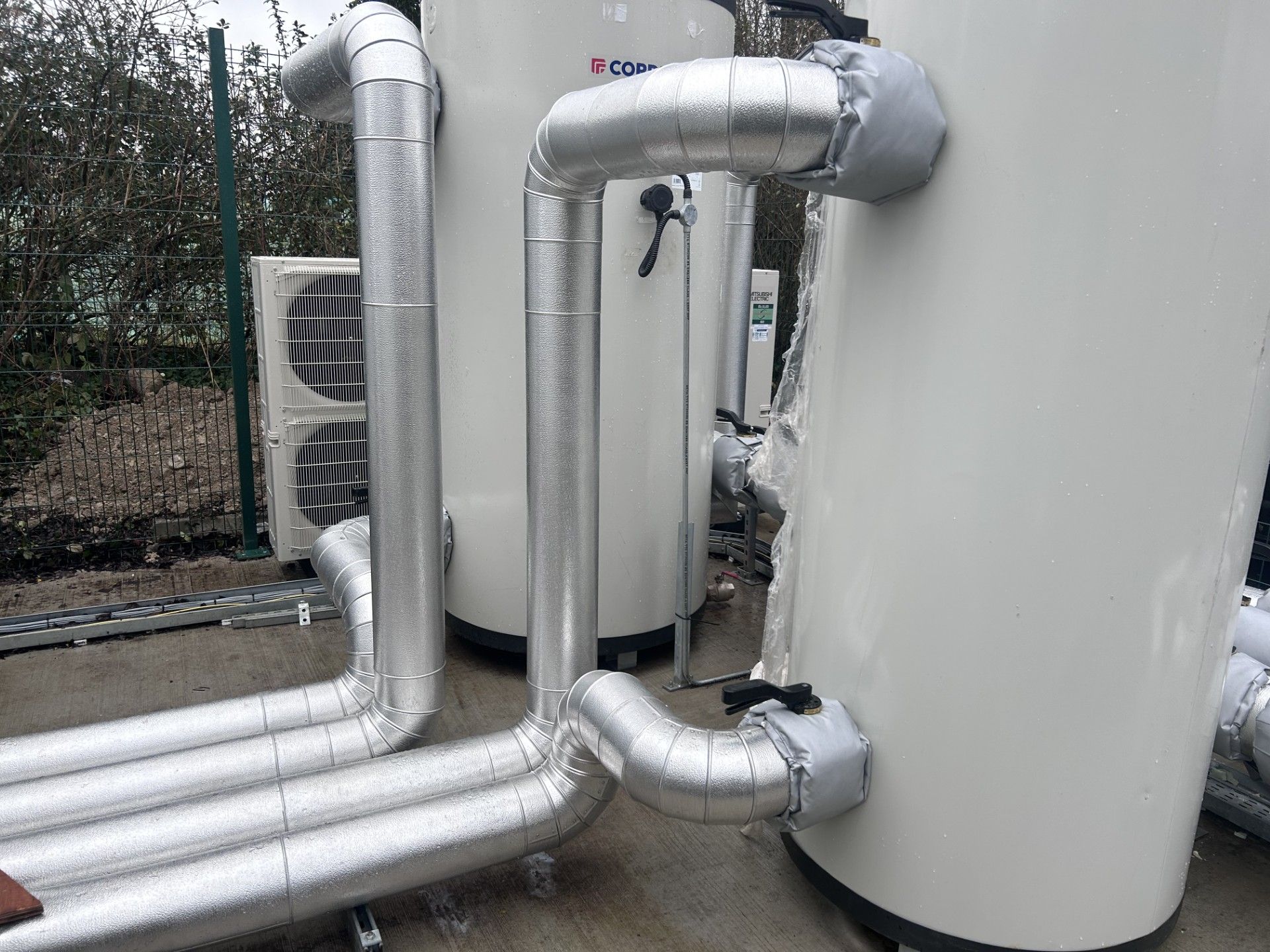 External pipework for chiller unit insulated with foiled fiberglass and clad with aluminium