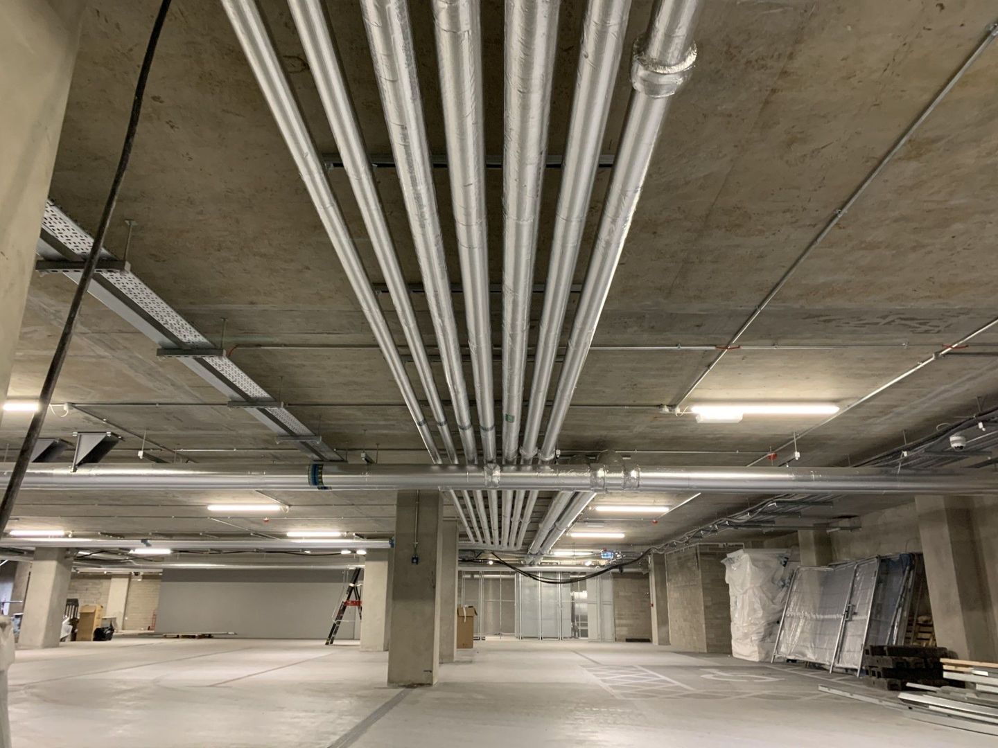 Underground car park services pipework insulated with foiled fiberglass lagging in Dublin Landings 