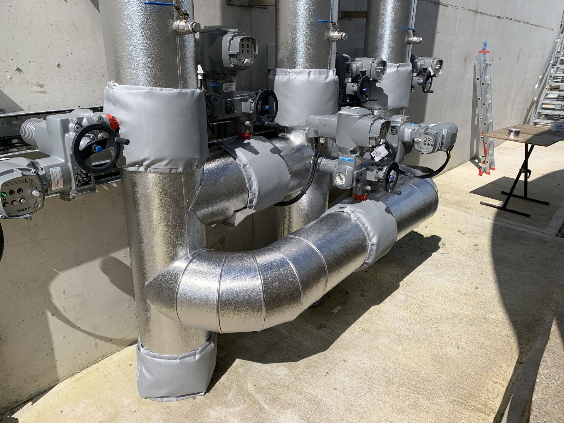 Pipework insulated with fiberglass rockwool sections and clad with aluminium in a waste water treatment facility in Donegal