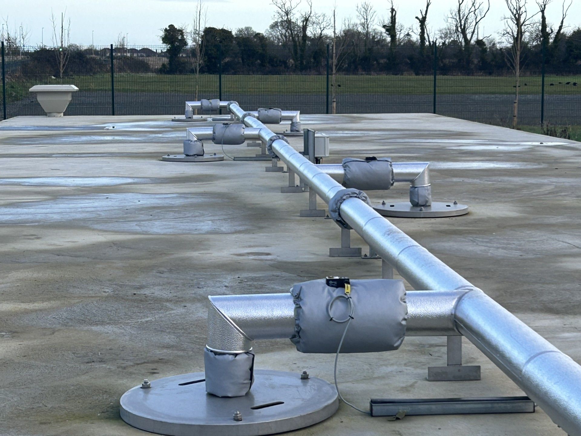 Pipework insulated with fiberglass rockwool sections and clad with aluminium in a waste water treatment facility in Donegal