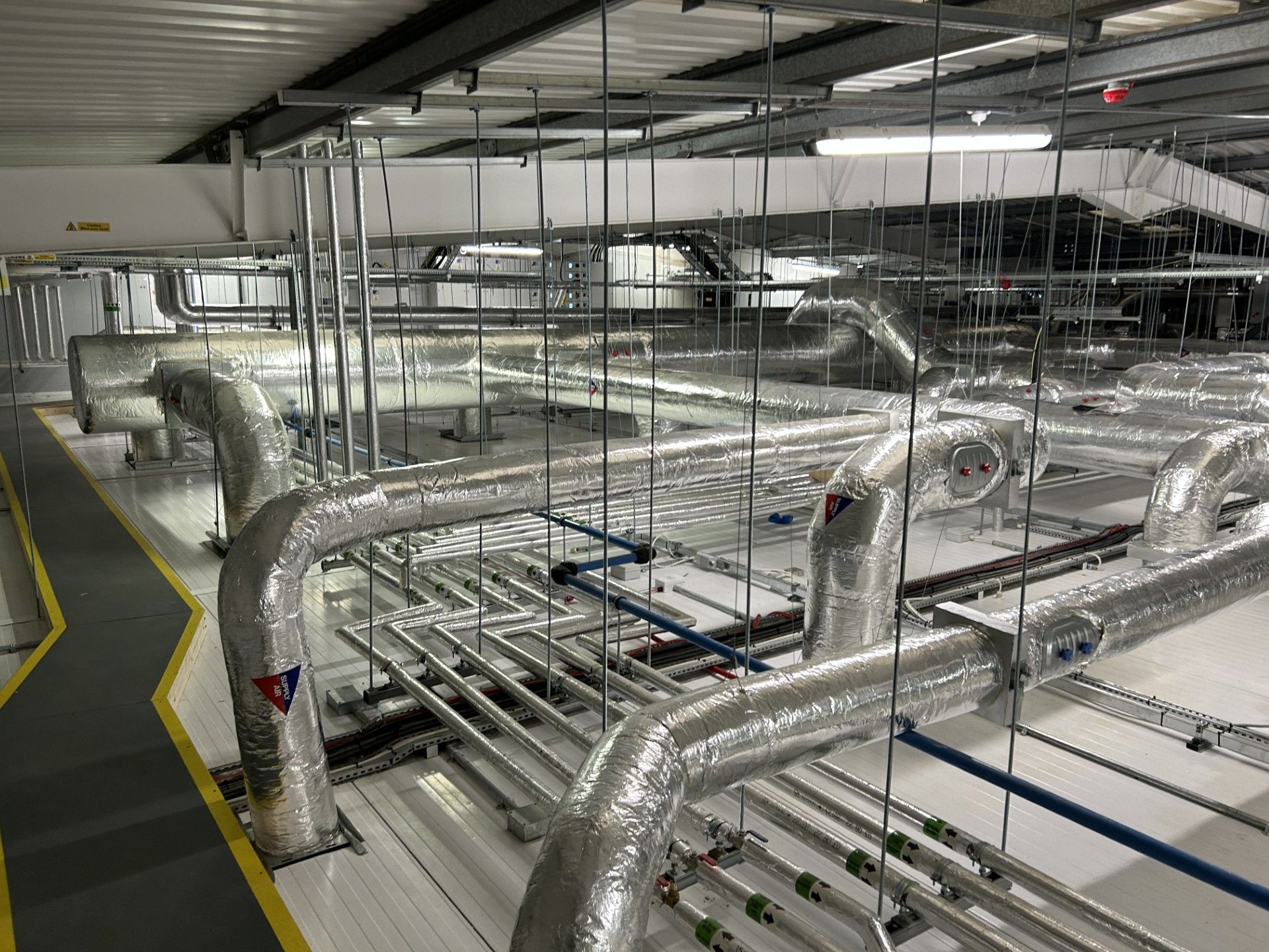 Ventilation ducting and water services pipework insulated with foiled fiberglass by Lagforce in Nass in Kildare