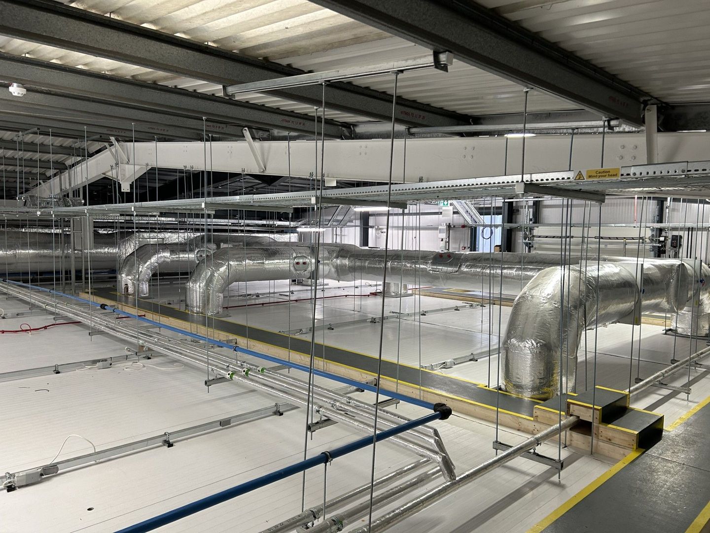 factory pipework services insulated with fiberglass insulation and HVAC ducting lagged with fiberglass ductwrap