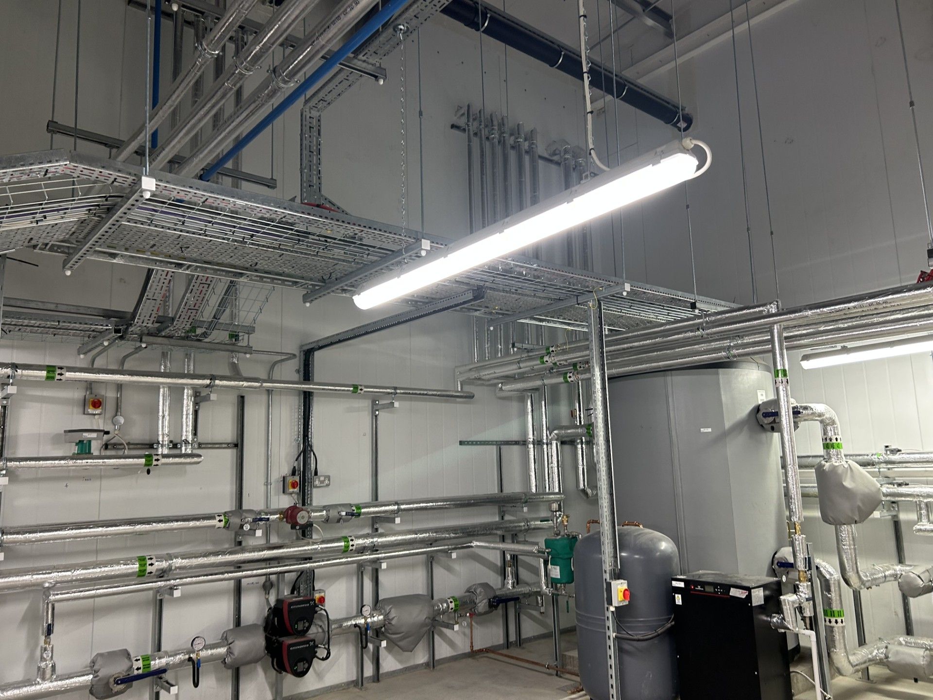 Boiler house water services pipework insulated with foiled fiberglass by Lagforce in Nass in Kildare