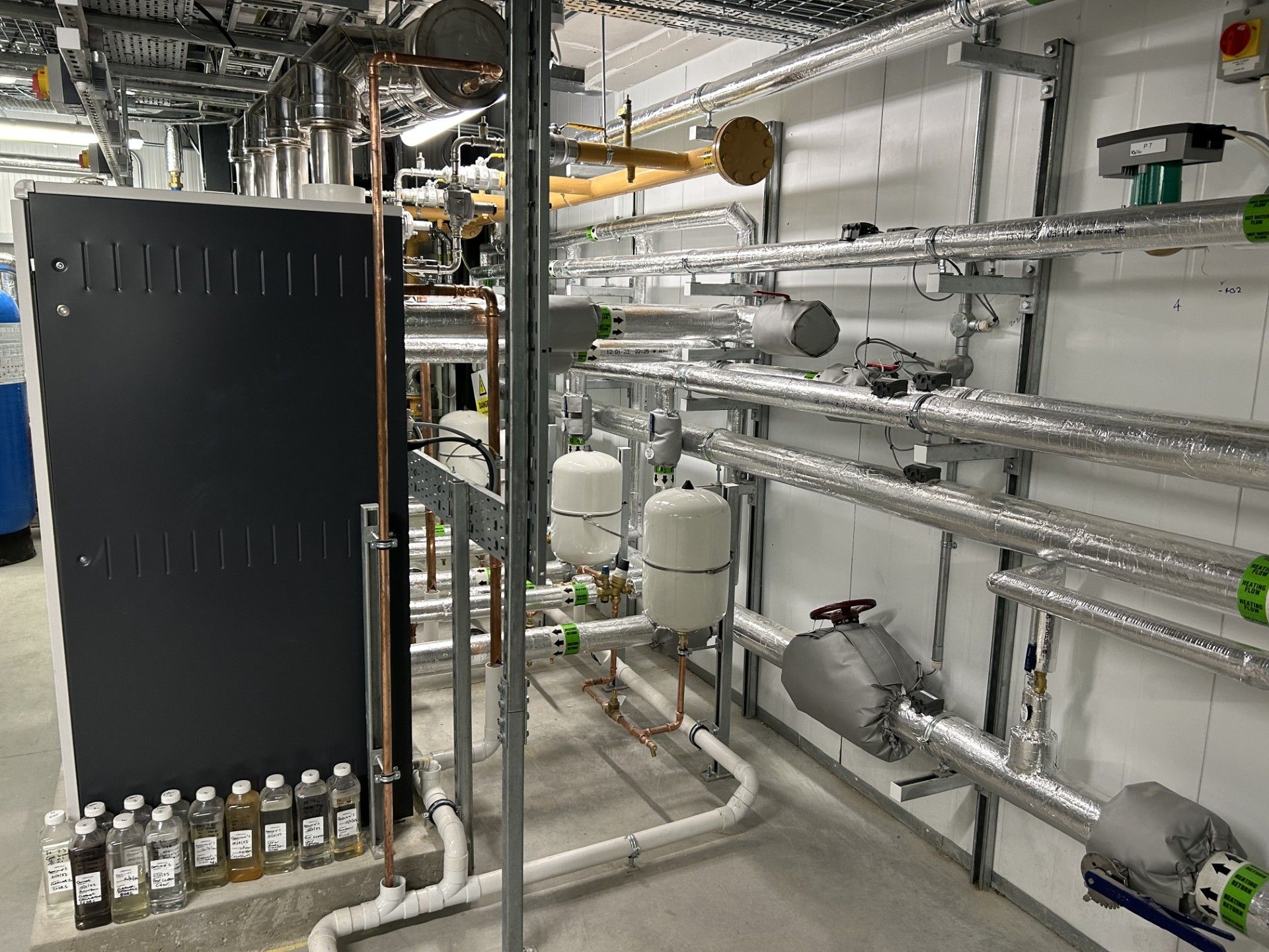 Boiler house water services pipework insulated with foiled fiberglass by Lagforce in Nass in Kildare