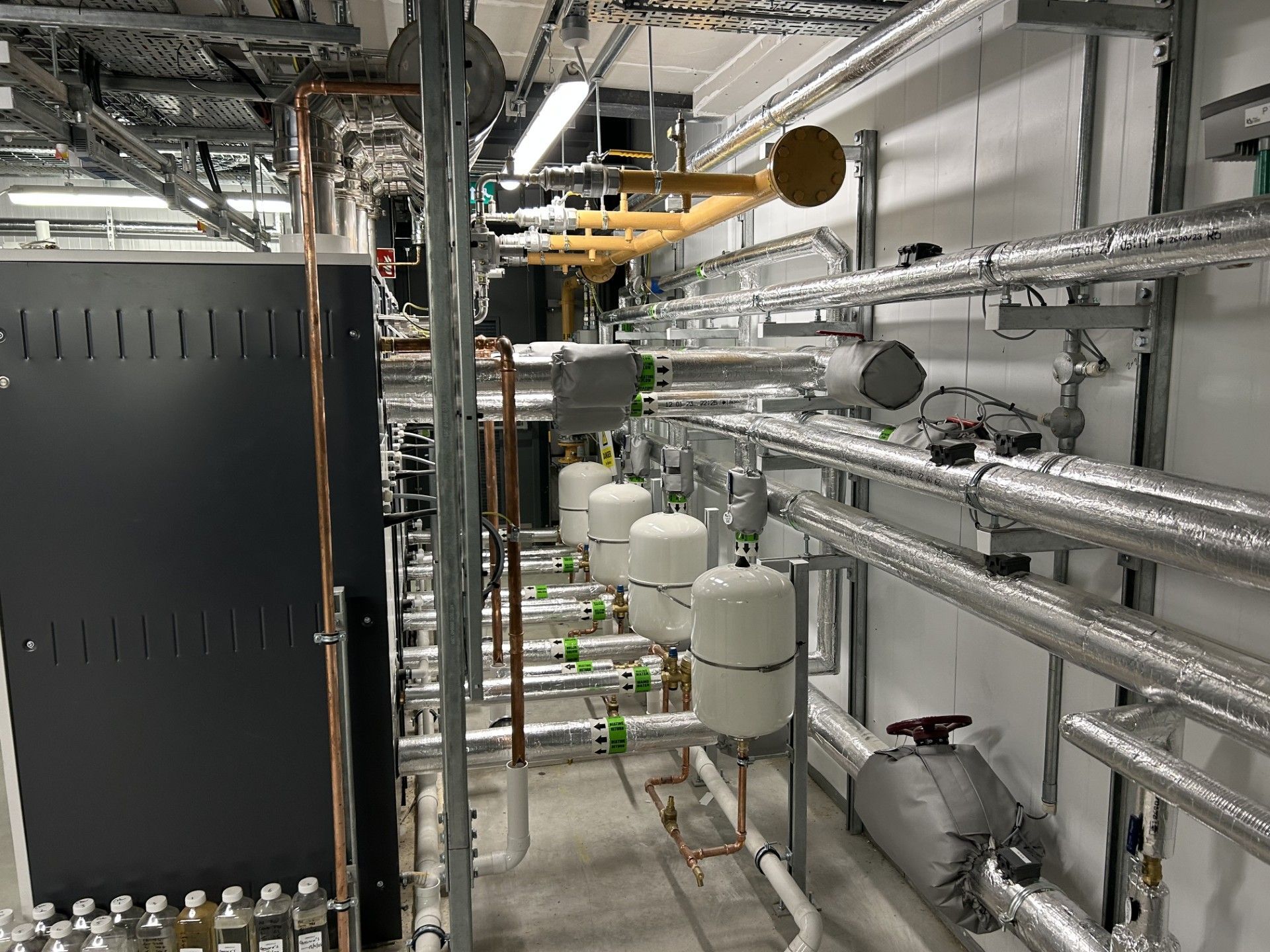 Boiler house water services pipework insulated with foiled fiberglass by Lagforce in Nass in Kildare