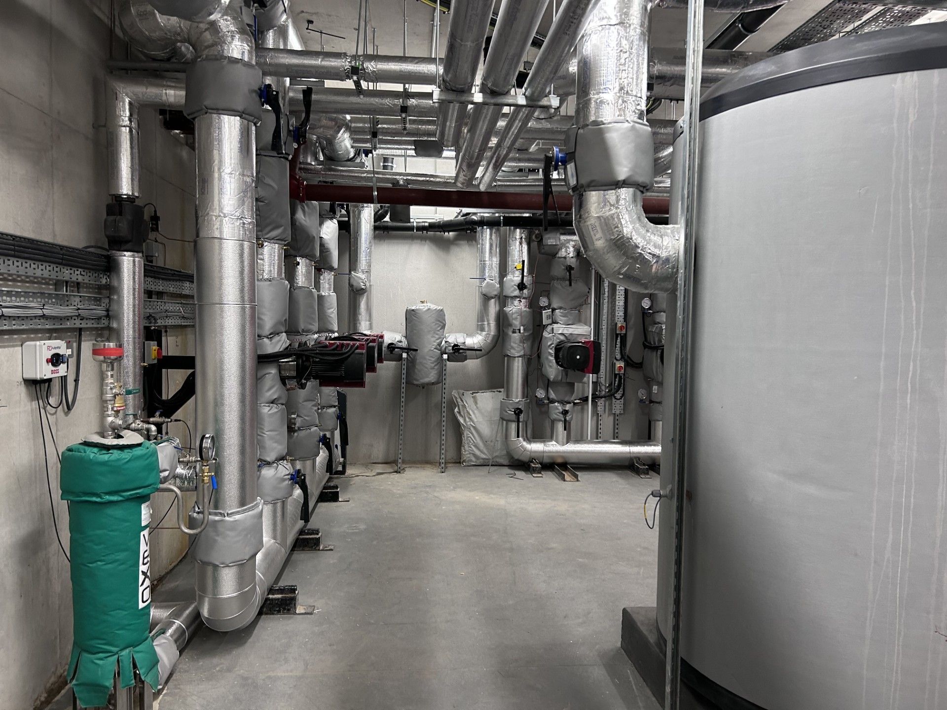 Insulation and protective aluminium cladding fitted to heating pipework in new energy center in Ireland