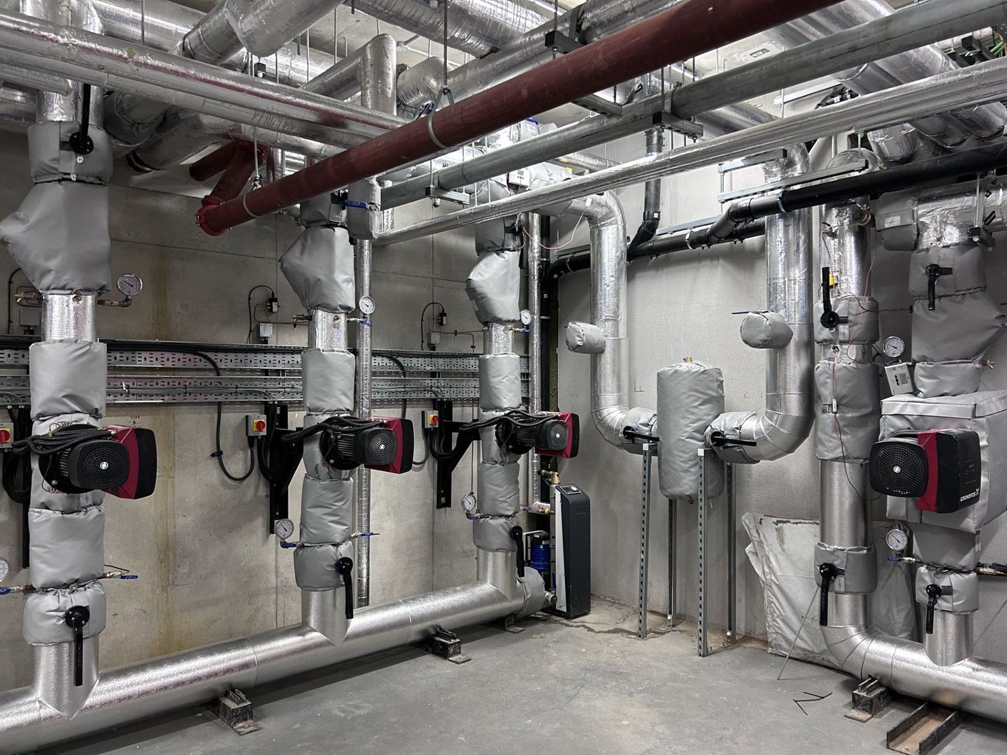 Boiler house services pipework insulated with phenolic insulation and clad with aluminium cladding and valve jackets