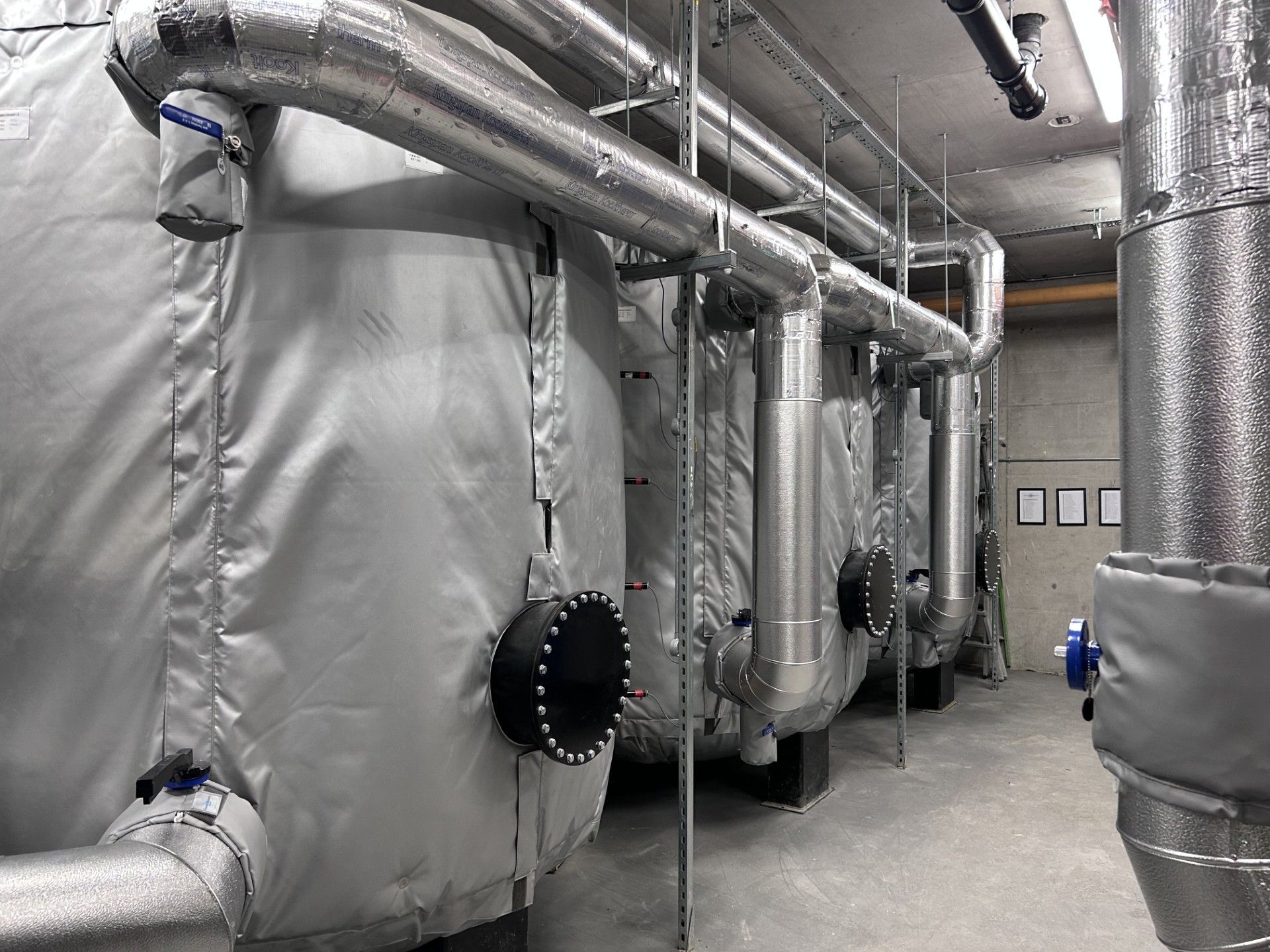 Three large heating buffer vessels in a plantroom insulated with high efficiency thermal covers supplied by lagforce in Dublin