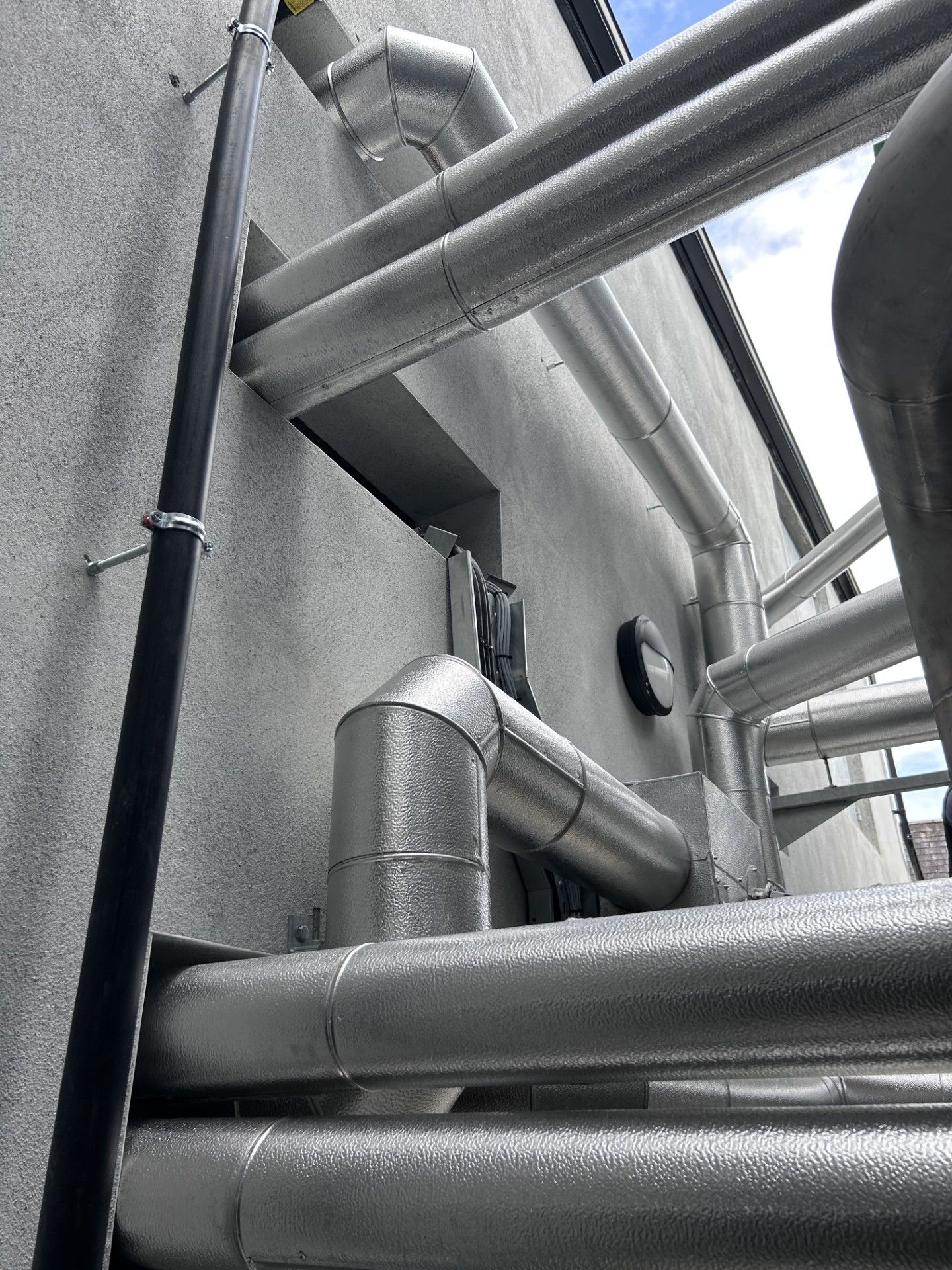 Exterior pipework in a distillery insulated and clad with aluminium cladding